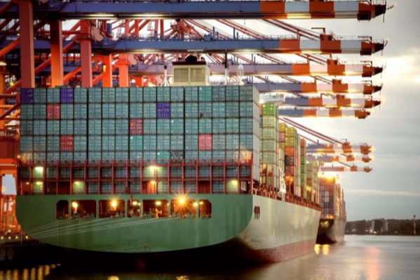 Cargo ship at busy port terminal