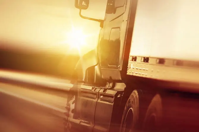 Semi-truck traveling during golden hour